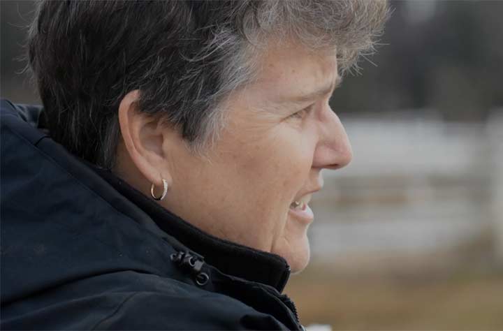 Catherine Baker looking out onto the horses at the equestrian center.