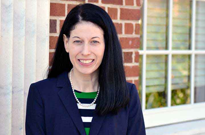 Professor Kara Kostluk smiles for the camera outside of Taylor building.