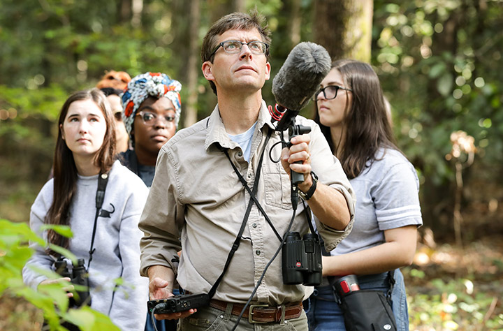 Jim with microphone in woods