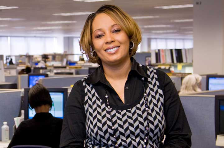 Karen Kee stands in her GEICO office.