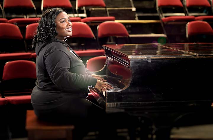 Rawlanda Hercules sits at the piano