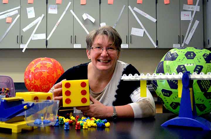 Virginia B. Wilcox surrounded by educational toys she uses to help teaching in the classroom