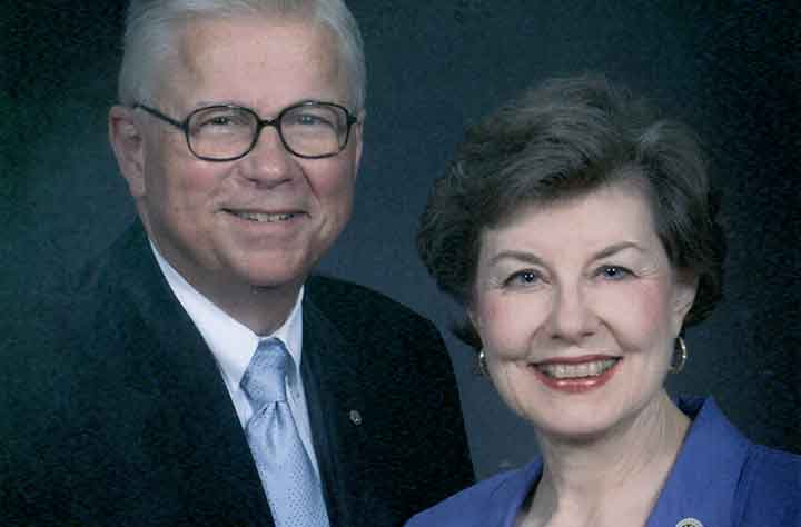 Jane Price Claxton stands beside her husband and smiles for the camera