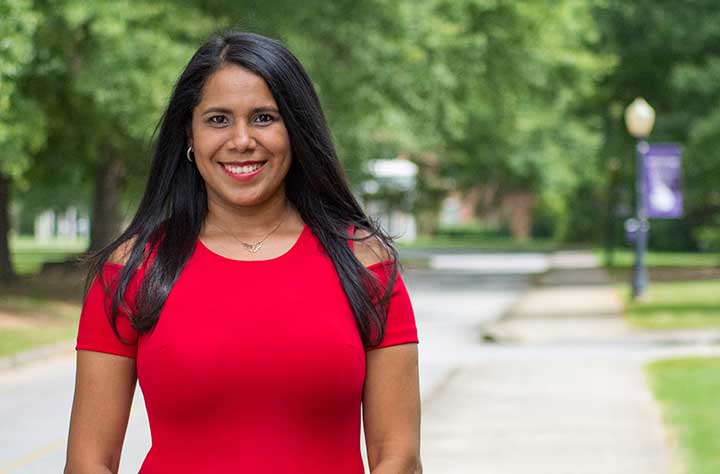 Staff member YASMIN PINEDA SEGURA smiles for the camera