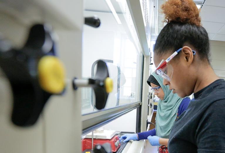 Chemistry students work on experiment in classroom