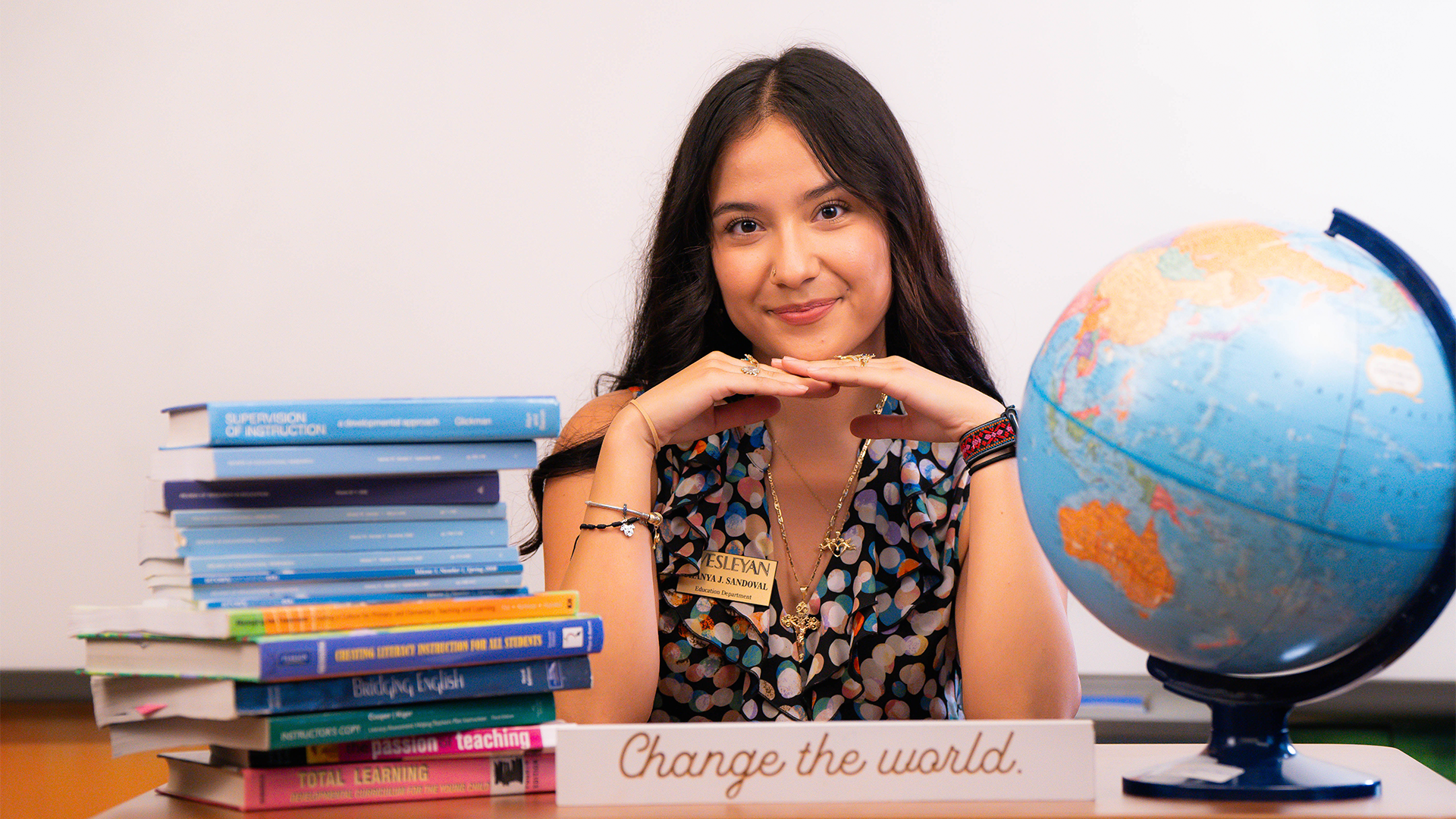 Peyton Anderson Scholarship Photo An education student posed around books and a globe