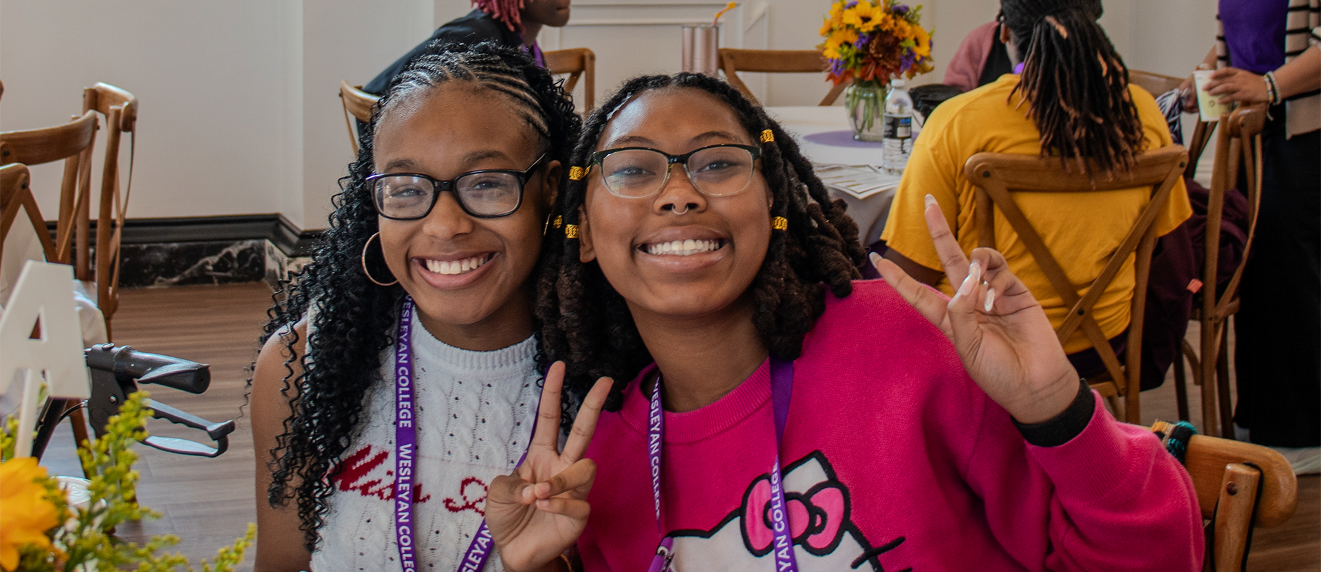EWD Students two students at a table, posing for a photo