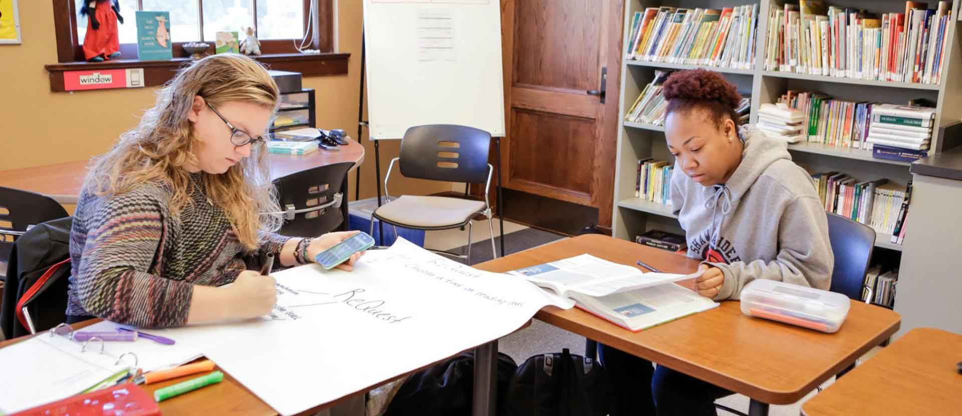 Students sitting in classroom working on school work