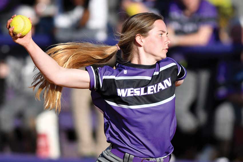 Softball player throwing the ball