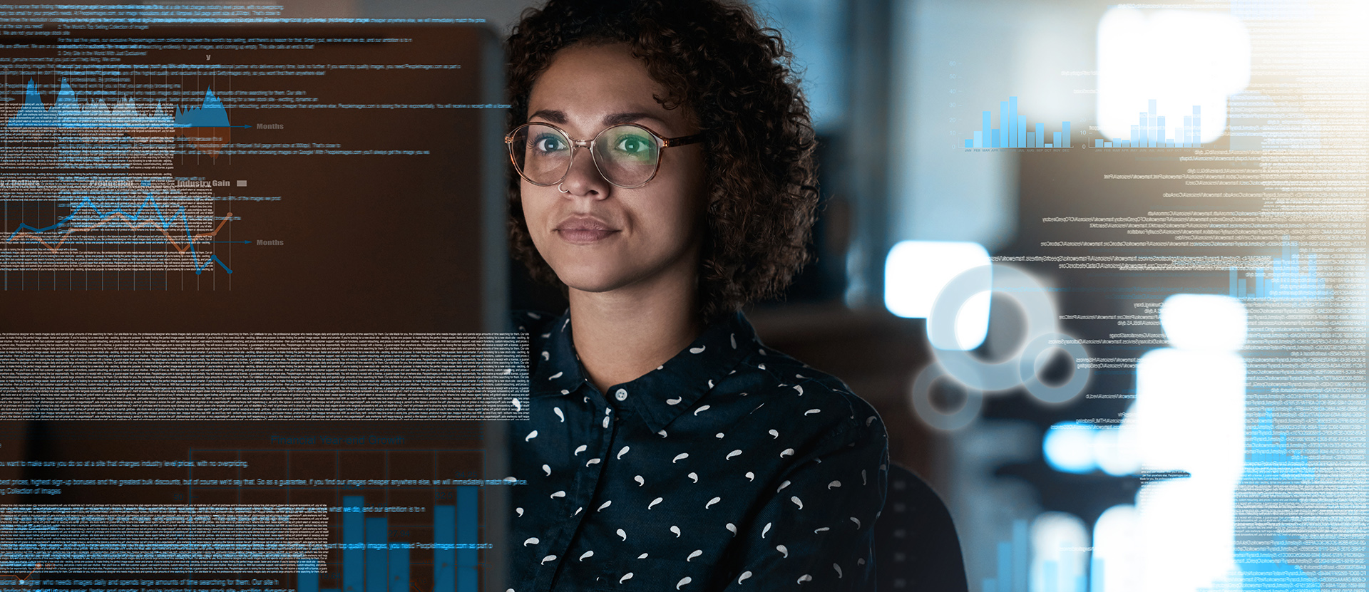Student looks at computer monitor with data in the background.