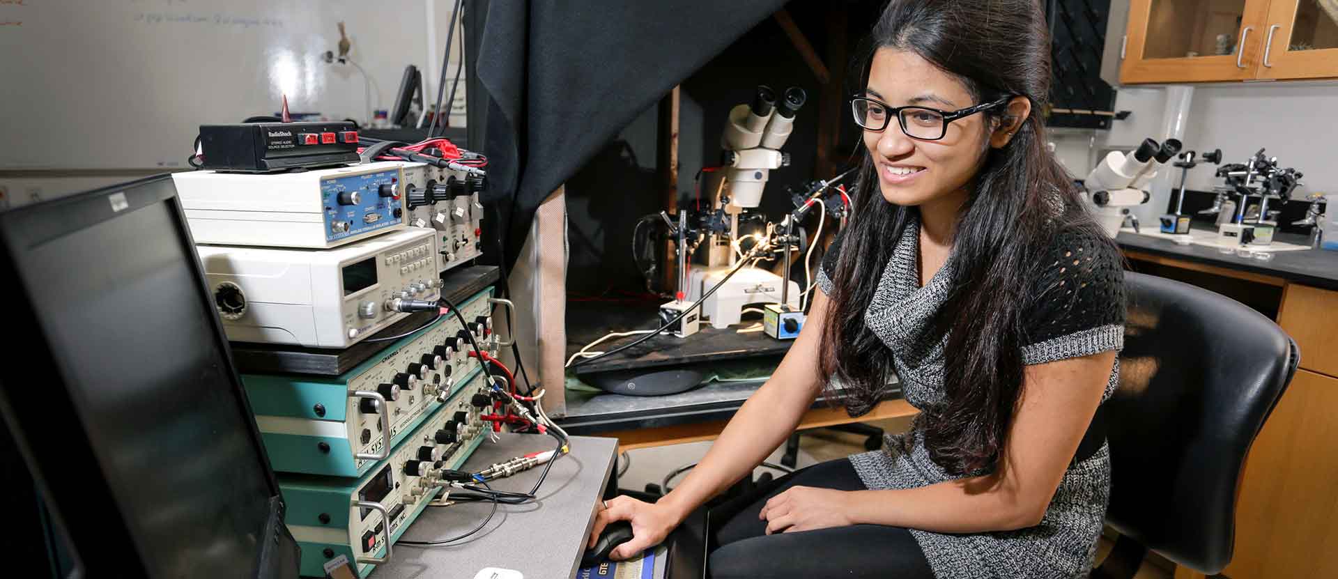 Biology student prepares for experiment in classroom