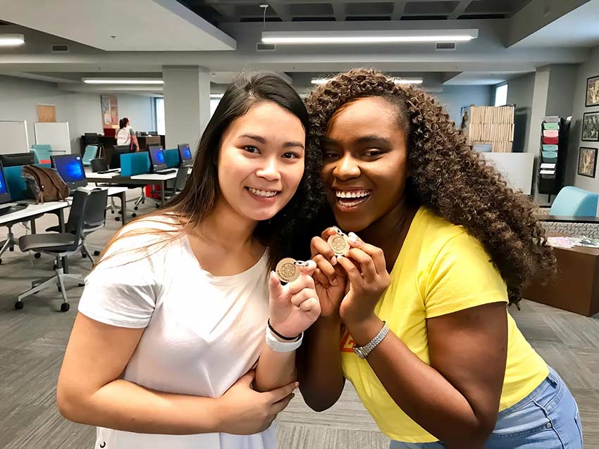 Students hold up Wesleyan keychain.