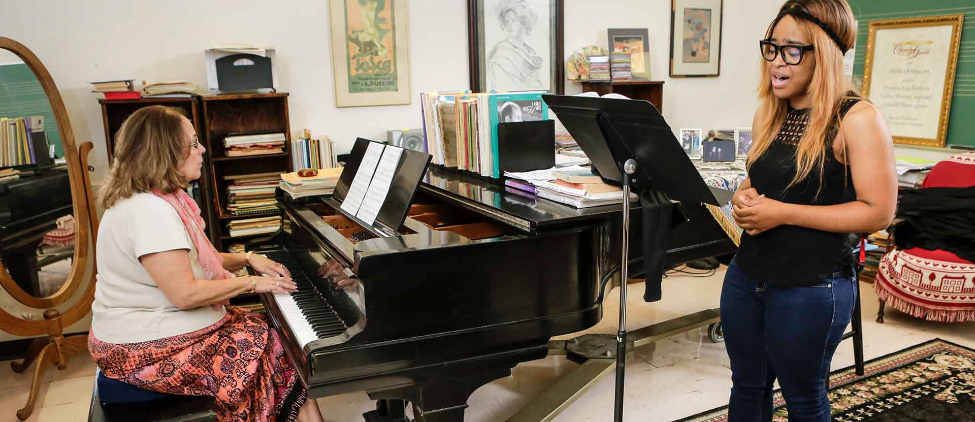 Music student practices singing with professor during her office hours