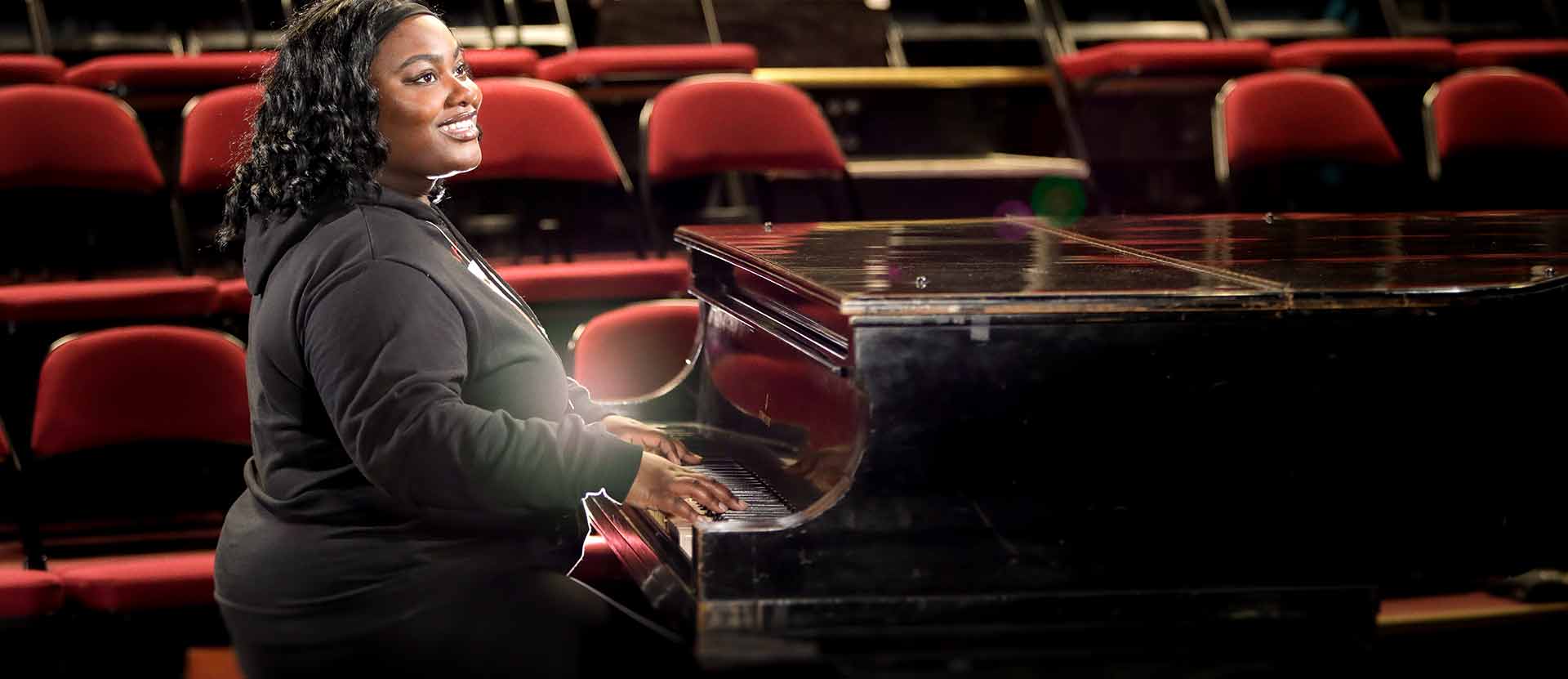 Music student playing the piano.