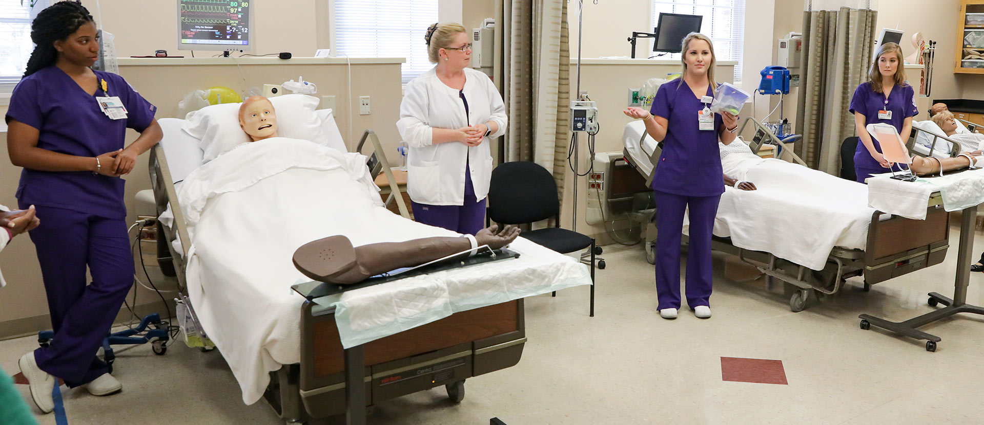 Nursing students and professors in Nursing lab.