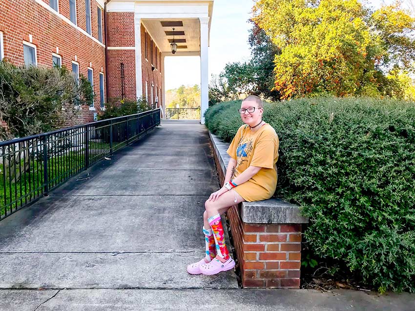 Student resting outside dorm.