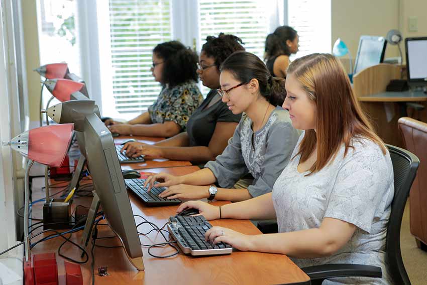 Line of students on computers.