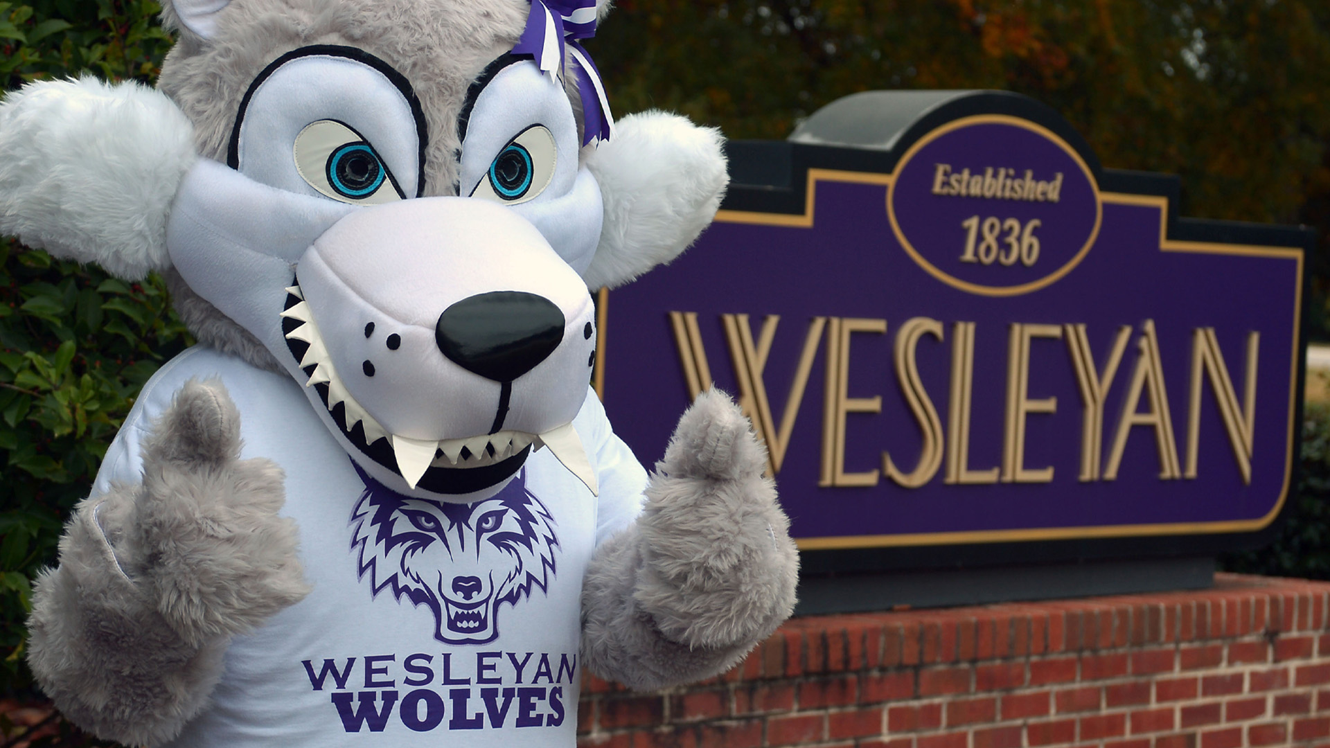 Dakota Dakota in front of Wesleyan Sign