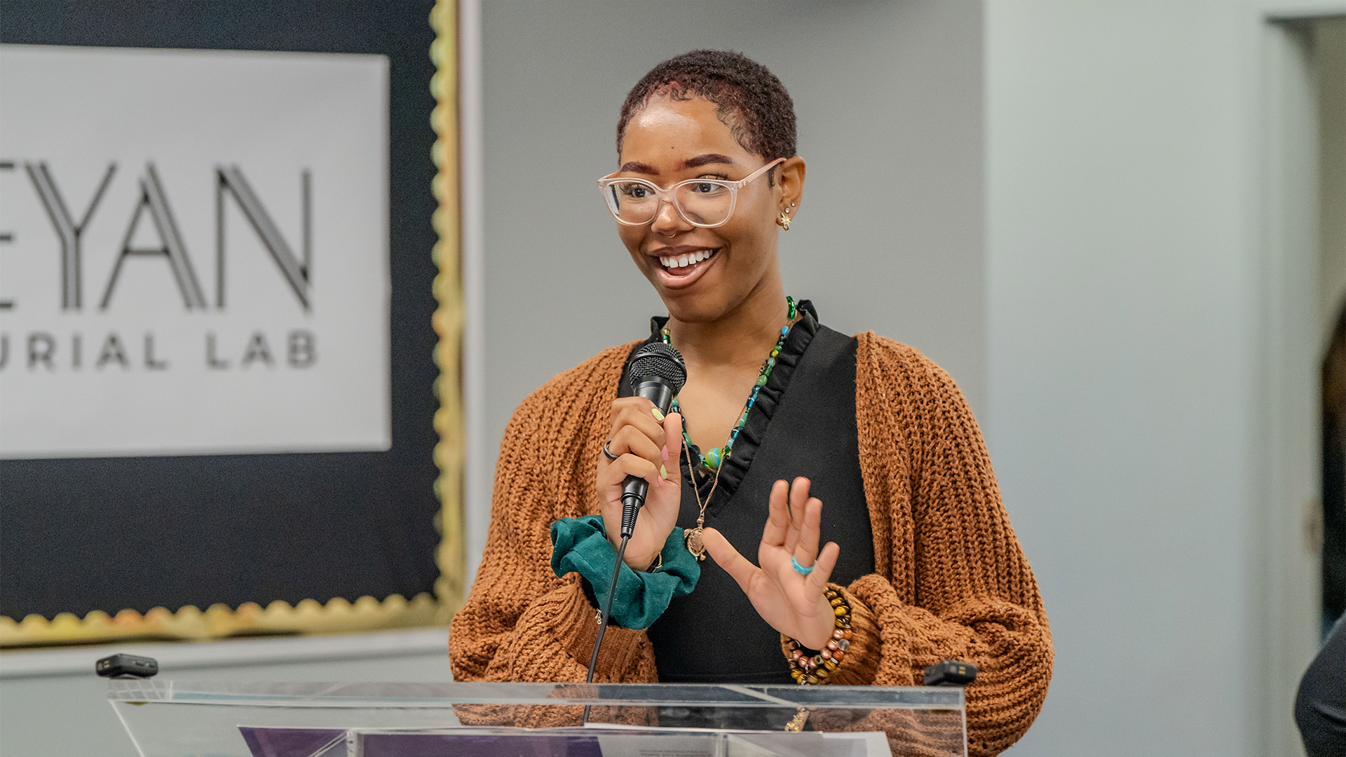 Female student giving a speech at a podium